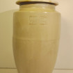 Large Asian jar covered in beige sandstone