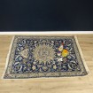 Old woollen rug with navy blue floral rosettes