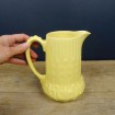 Yellow earthenware water jug