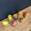 7 different hand-painted and glazed fruits in slip