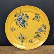 Nice plate or dish with blue flowers on a yellow background