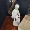 Child with fish in old porcelain biscuit