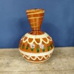 Brown glazed terracotta vase with beige and green lines and festoons